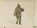 Image of Tom McCue, the cook - returning to ship with white fox.